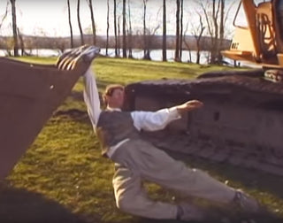 JUST A MAN DANCING W/ AN EXCAVATOR